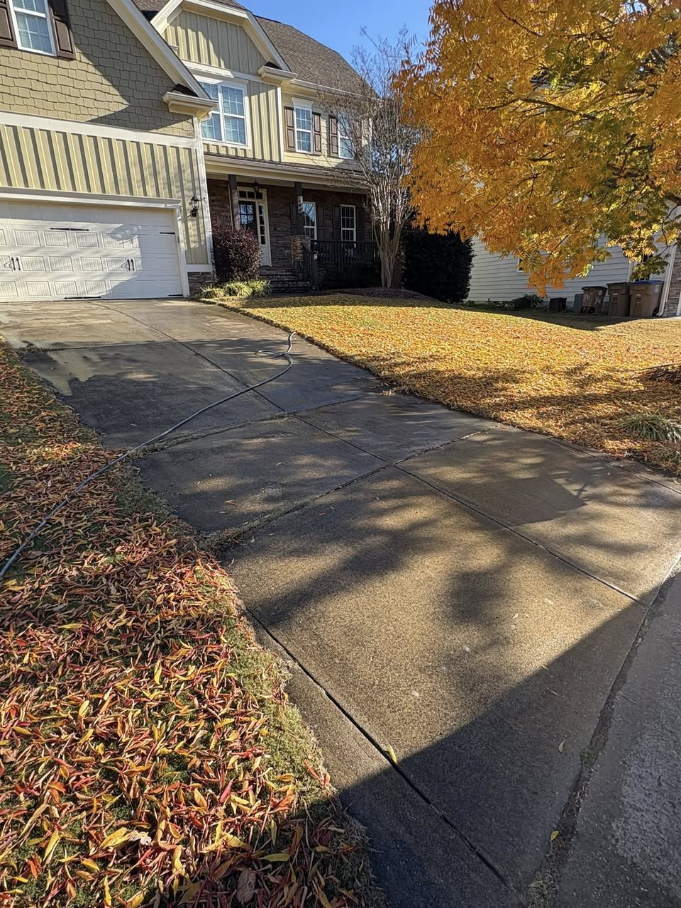 Driveway after pressure washing — half clean, half dirty